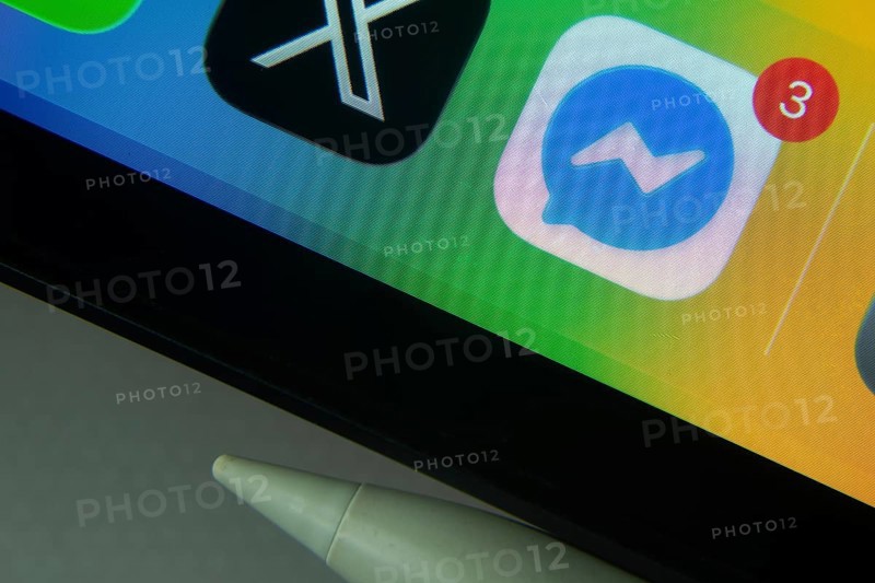 16 Nov 2025- Dhaka, Bangladesh: Messenger and other app icons with a digital pen on a iPad screen