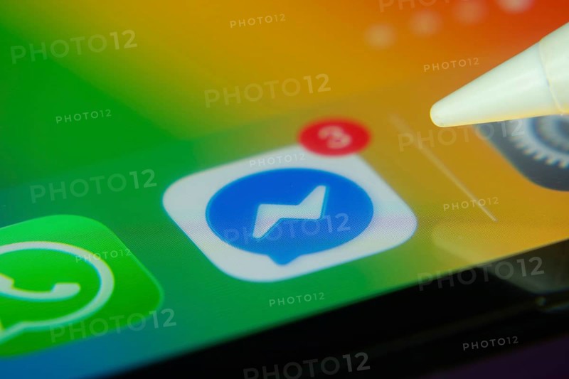 16 Nov 2025- Dhaka, Bangladesh: Stylus touching the Facebook Messenger app icon with a notification on a smartphone screen
