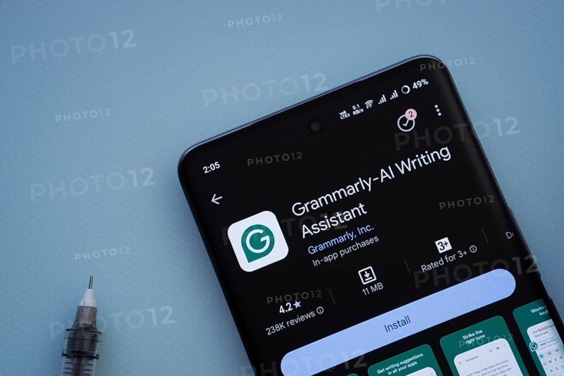 Dhaka, Bangladesh- 29 May 2025: On a blue surface, a smartphone displays the Grammarly app within the Google Play Store