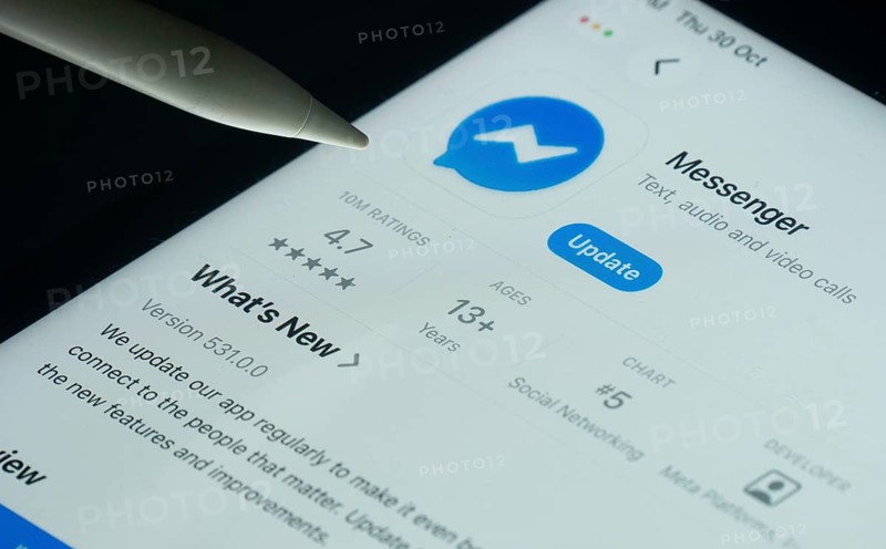 Dhaka, Bangladesh- 30 Oct 2025: Facebook Messenger app on a iPad screen with a pen pointing at the install option
