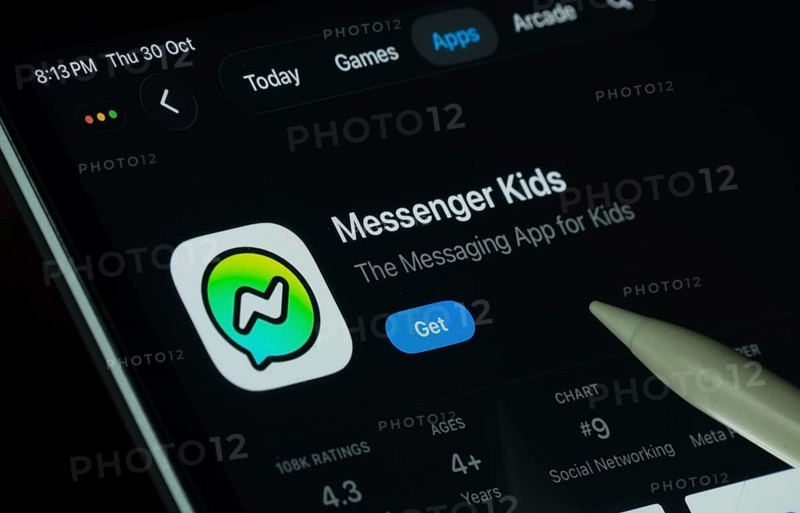 Dhaka, Bangladesh- 30 Oct 2025: Messenger Kids app displayed on a iPad screen in dark mode with a digital pen pointing at it