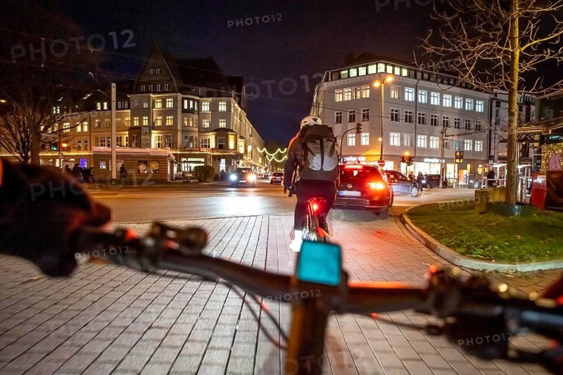 Cycling in the city, in the dark, in the evening, inner-city road, bicycle road, two-wheeler traffic has priority, 30 km/h zone, cyclist perspective, Essen, North Rhine-Westphalia, Germany