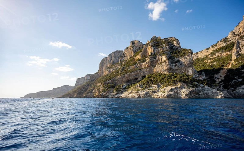 Picturesque rocky coast, cliffs in morning light, blue sea, Golfo di Orosei, Baunei, Sardinia, Italy