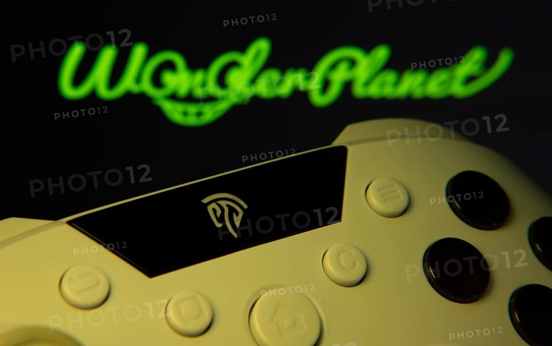 Dhaka, Bangladesh- 14 Nov 2025: A close-up of a gamepad with the WonderPlanet Inc seen on screen in the background