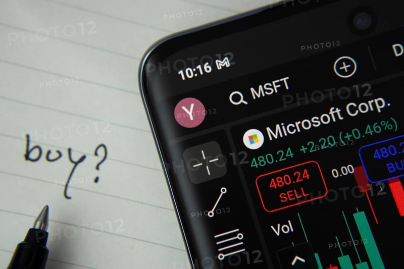 Dhaka, Bangladesh- 20 June 2025: Microsoft corporation stock trading details displayed on smartphone with handwritten note