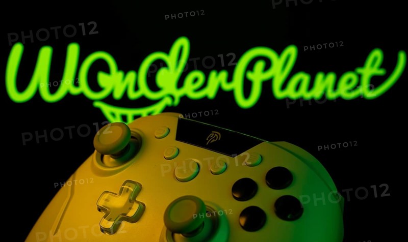 Dhaka, Bangladesh- 14 Nov 2025: A close-up of a gamepad with the WonderPlanet Inc seen on screen in the background