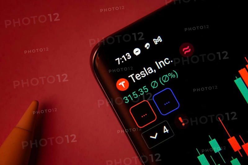 Dhaka, Bangladesh- 08 Sep 2025: Close-up of a phone screen showing Tesla Inc stock market data with a candlestick chart