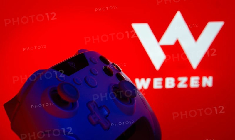 Dhaka, Bangladesh- 14 Nov 2025: A close-up of a gamepad with the Webzen seen on screen in the background