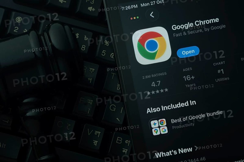 Dhaka, Bangladesh- 28 Oct 2025: An iPad displaying the Google Chrome app against a judge's gavel and dark keyboard background