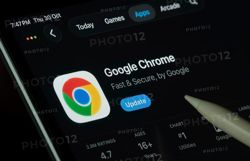 Dhaka, Bangladesh- 30 Oct 2025: Google Chrome app displayed on a iPad screen in dark mode with a digital pen pointing at it