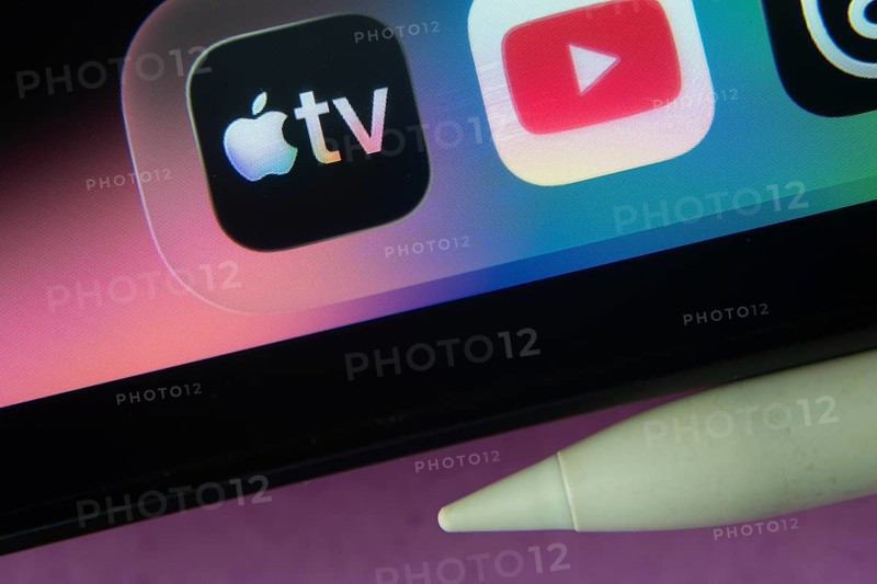 16 Nov 2025- Dhaka, Bangladesh: Apple TV and other app icons with a digital pen on a iPad screen