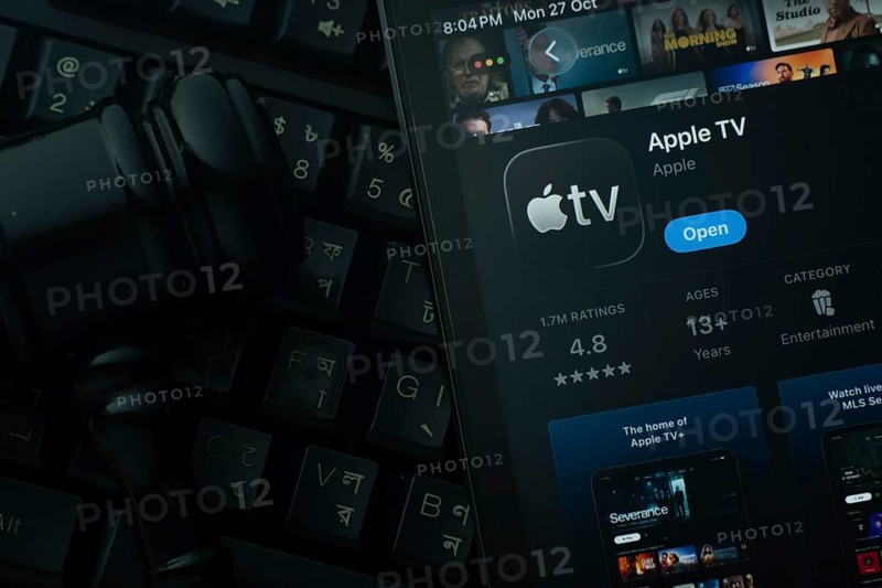 Dhaka, Bangladesh- 28 Oct 2025: An iPad displaying the Apple TV app against a judge's gavel and dark keyboard background