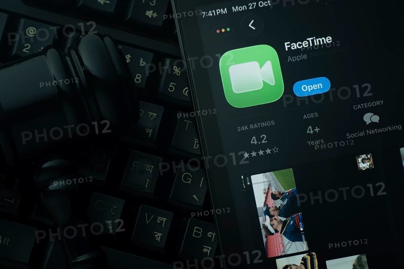 Dhaka, Bangladesh- 28 Oct 2025: An iPad displaying the Apple Facetime app against a judge's gavel and dark keyboard background
