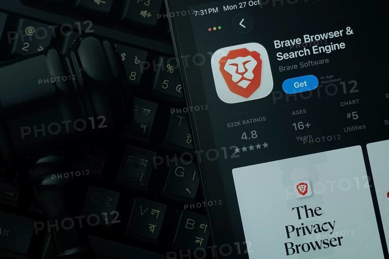 Dhaka, Bangladesh- 28 Oct 2025: An iPad displaying the Brave browser app against a judge's gavel and dark keyboard background