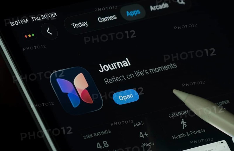 Dhaka, Bangladesh- 30 Oct 2025: Apple Journal app displayed on a iPad screen in dark mode with a digital pen pointing at it