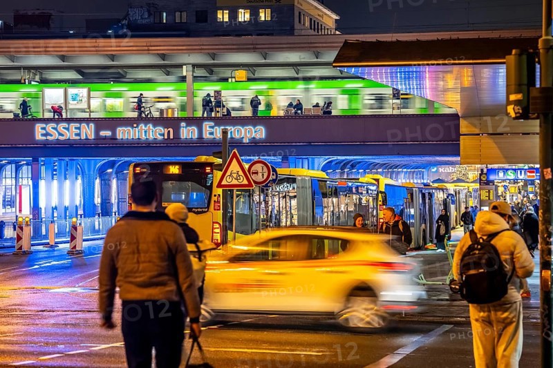 The main train station in Essen, blue illuminated underpass, bus station, am Europaplatz, train on the platform, pedestrian crossing, North Rhine-Westphalia, Germany