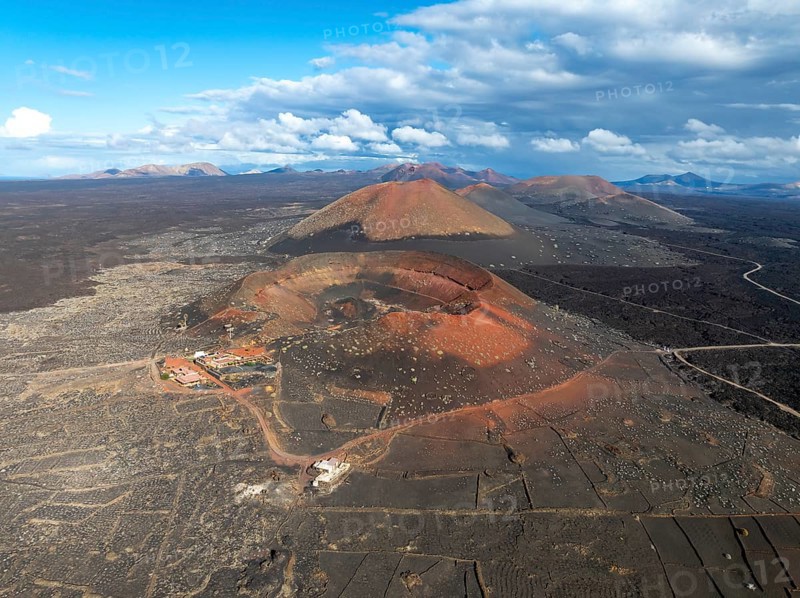 Montaña Quemada and Montaña Pedro Perico volcanoes, volcanic landscape with craters and lava fields, aerial view, Lanzarote, Canary Islands, Spain