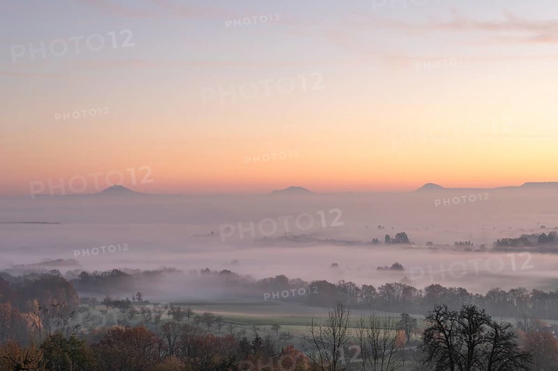 Three Kaiserberge mountains in golden morning light, Hohenstaufen, Aichelberg. Spectacular dawn over the foggy foothills of Baden-Württemberg