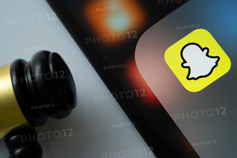 Dhaka, Bangladesh- 17 March 2025: A close up of an iPad screen displaying the Snapchat app alongside a judge's gavel