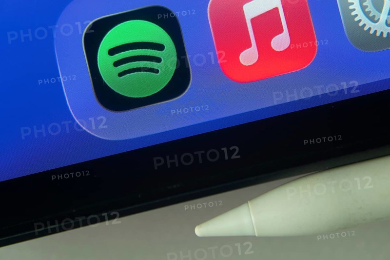 16 Nov 2025- Dhaka, Bangladesh: Spotify and Apple Music and other app icons with a digital pen on a iPad screen