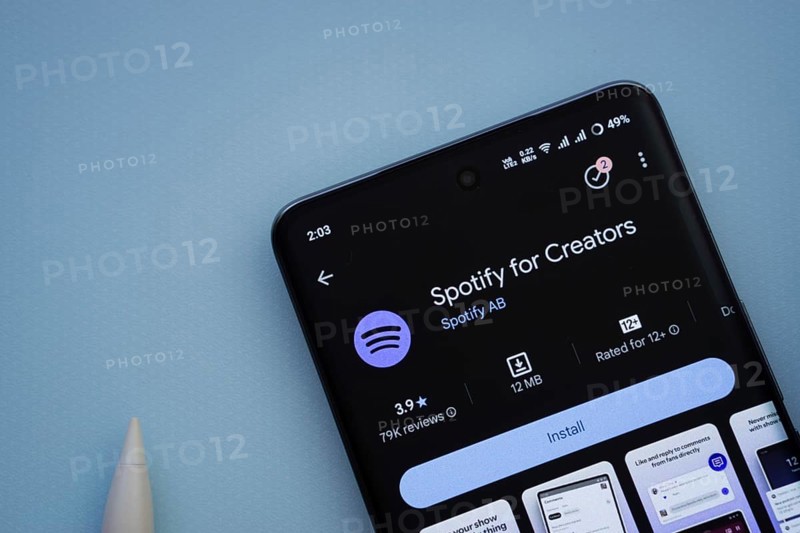 Dhaka, Bangladesh- 29 May 2025: On a blue surface, a smartphone displays the Spotify for Creators app within the Google Play Store