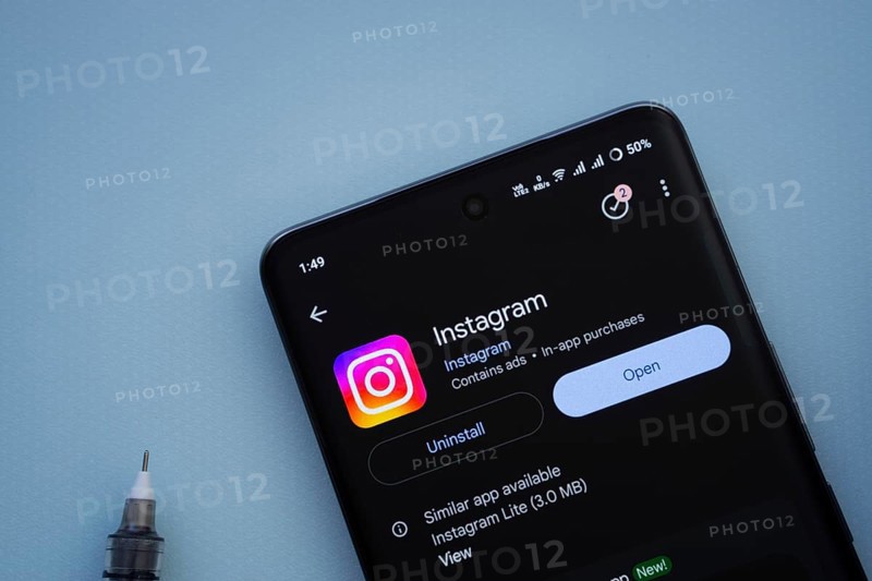 Dhaka, Bangladesh- 29 May 2025: On a blue surface, a smartphone displays the Instagram app within the Google Play Store