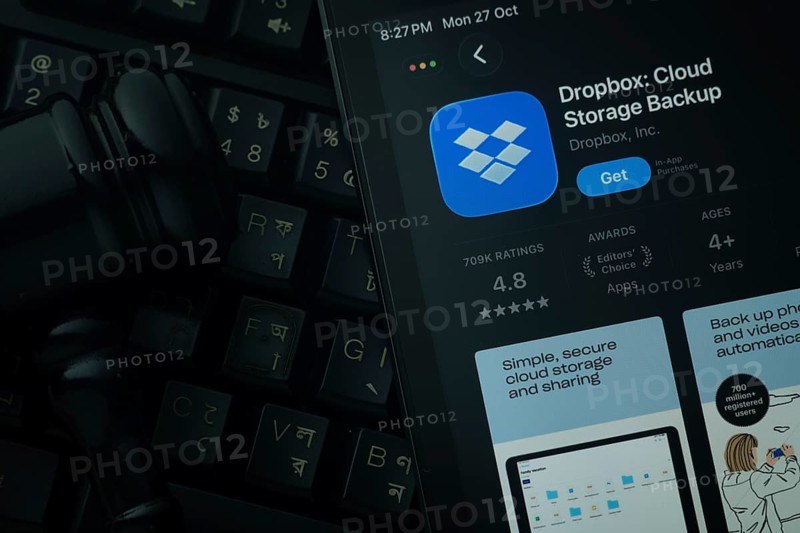 Dhaka, Bangladesh- 28 Oct 2025: An iPad displaying the Dropbox app against a judge's gavel and dark keyboard background