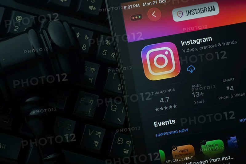 Dhaka, Bangladesh- 28 Oct 2025: An iPad displaying the Instagram app against a judge's gavel and dark keyboard background