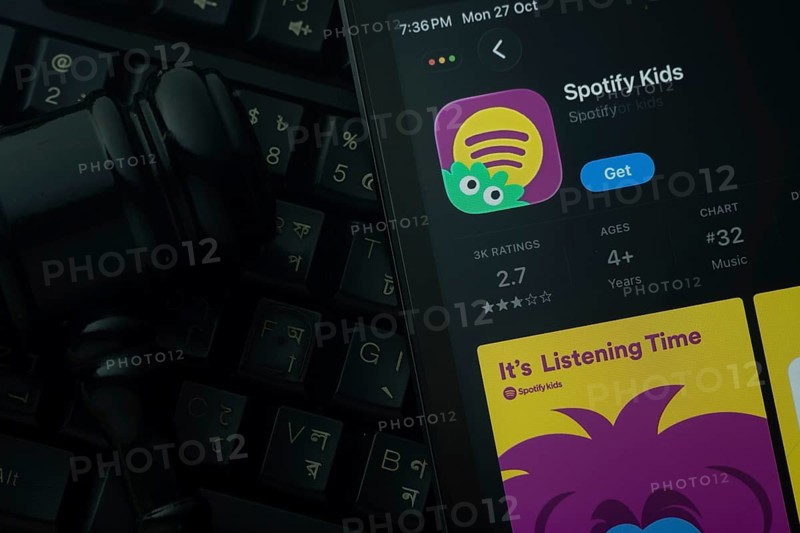 Dhaka, Bangladesh- 28 Oct 2025: An iPad displaying the Spotify Kids app against a judge's gavel and dark keyboard background