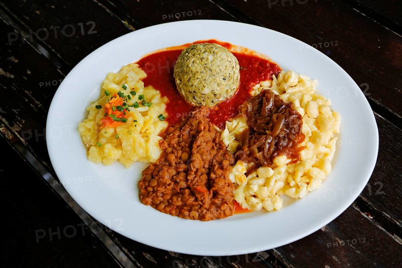 Swabian cuisine, potato salad with flavored onions, spätzle, knöpfle, dumplings with tomato sauce, vegetarian, plate, main course served on plate, grandmother's cuisine, regional, home cooking, typical Swabian, traditional cuisine, food photography, Germany
