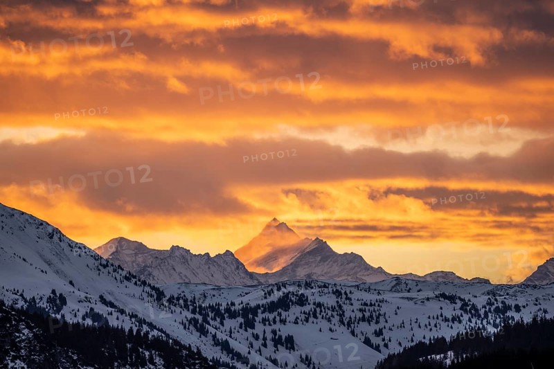 Grossglockner peaks at sunset in winter, spectacular cloudy skies, Hochbrixen, Brixen im Thale, Tyrol, Austria