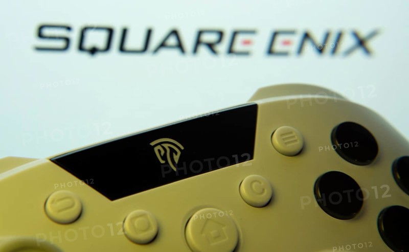 Dhaka, Bangladesh- 14 Nov 2025: A close-up of a gamepad with the Square Enix seen on screen in the background