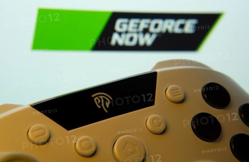 Dhaka, Bangladesh- 14 Nov 2025: A close-up of a gamepad with the Geforce Now seen on screen in the background
