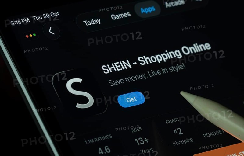 Dhaka, Bangladesh- 30 Oct 2025: SHEIN app displayed on a iPad screen in dark mode with a digital pen pointing at it