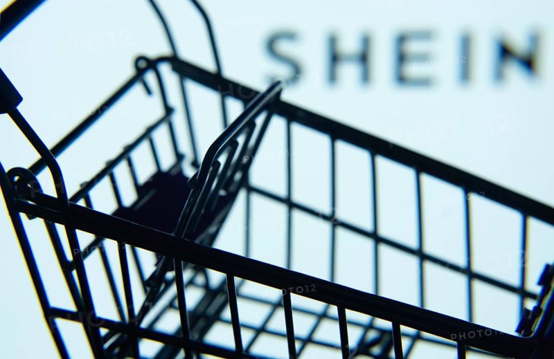 Dhaka, Bangladesh- 03 July 2025: Silhouette of a shopping cart in front of the SHEIN logo, symbolizing ecommerce and online shopping