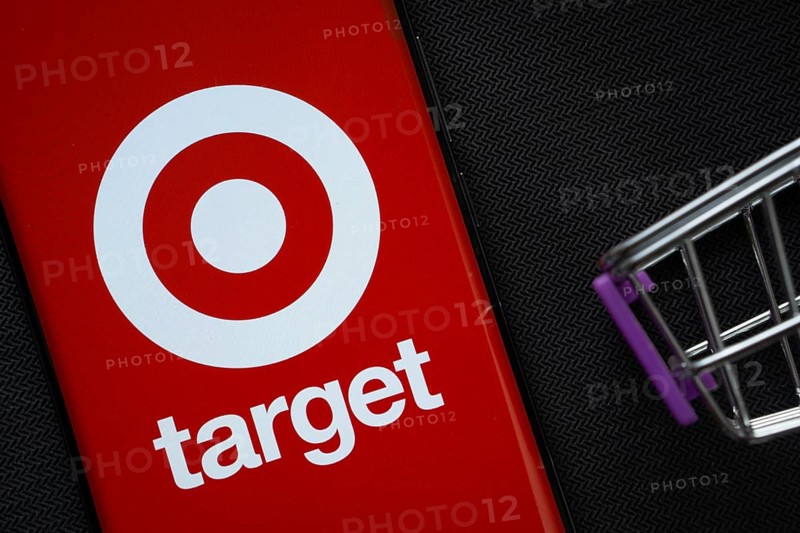 Dhaka, Bangladesh- 03 July 2025: A smartphone displaying the Target logo next to a miniature shopping cart on a background