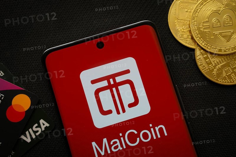 Dhaka, Bangladesh- 06 Sep 2025: Smartphone displaying MaiCoin logo surrounded by Bitcoin coins and payment cards