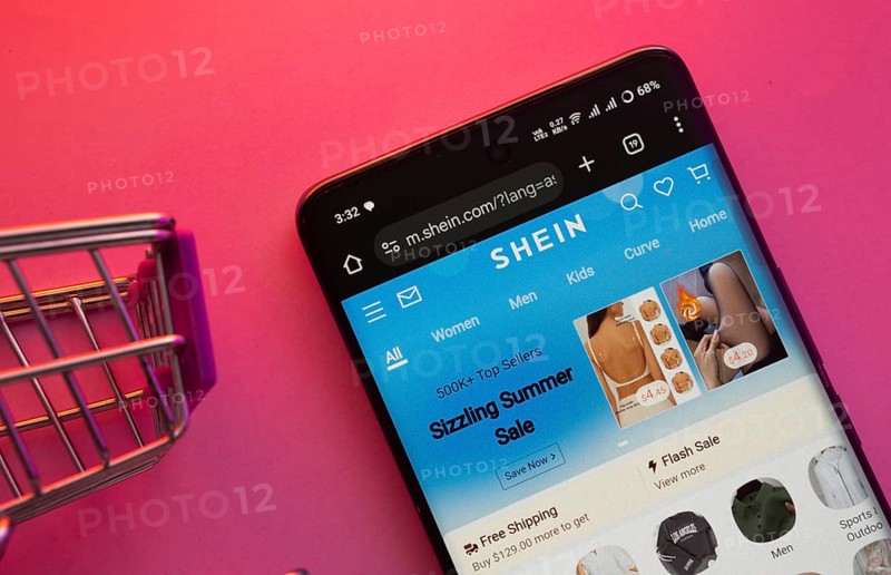 Dhaka, Bangladesh- 23 June 2025: A smartphone displaying the SHEIN website with a shopping cart is shown on a vibrant background