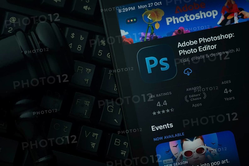 Dhaka, Bangladesh- 28 Oct 2025: An iPad displaying the Adobe Photoshop app against a judge's gavel and dark keyboard background