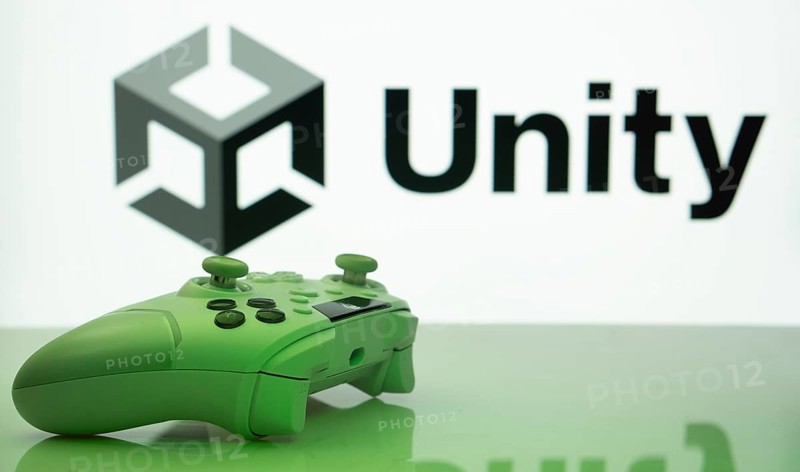Dhaka, Bangladesh- 14 Nov 2025: A close-up of a white gamepad with the Unity seen on screen in the background
