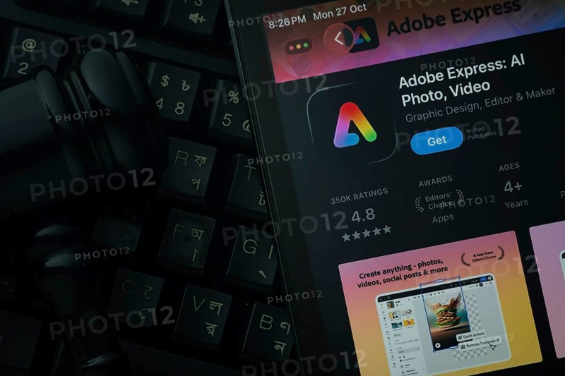Dhaka, Bangladesh- 28 Oct 2025: An iPad displaying the Adobe Express app against a judge's gavel and dark keyboard background