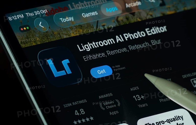 Dhaka, Bangladesh- 30 Oct 2025: Lightroom Ai app displayed on a iPad screen in dark mode with a digital pen pointing at it