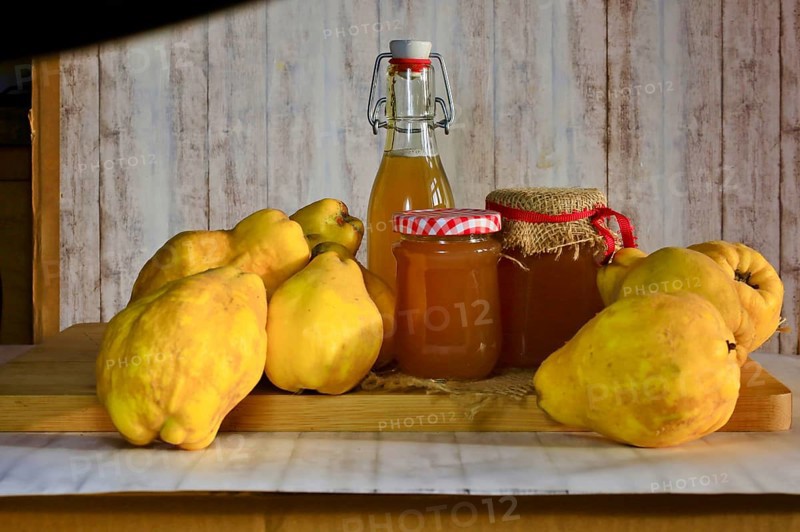 Still life with quinces, homemade quince jelly and quince liqueur, autumn, Germany