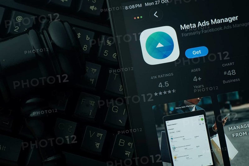 Dhaka, Bangladesh- 28 Oct 2025: An iPad displaying the meta ads manager app against a judge's gavel and dark keyboard background