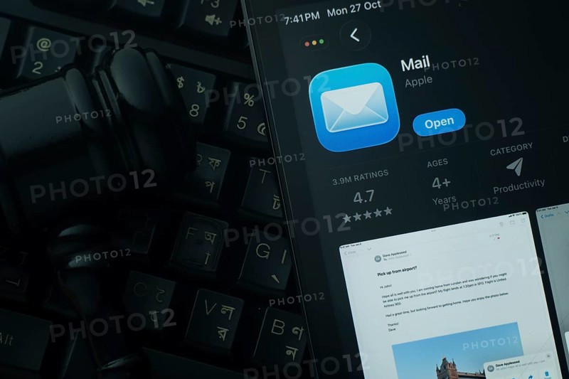 Dhaka, Bangladesh- 28 Oct 2025: An iPad displaying the Apple Mail app against a judge's gavel and dark keyboard background
