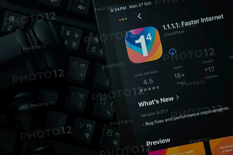 Dhaka, Bangladesh- 28 Oct 2025: An iPad displaying the 1.1.1.1 VPN app against a judge's gavel and dark keyboard background