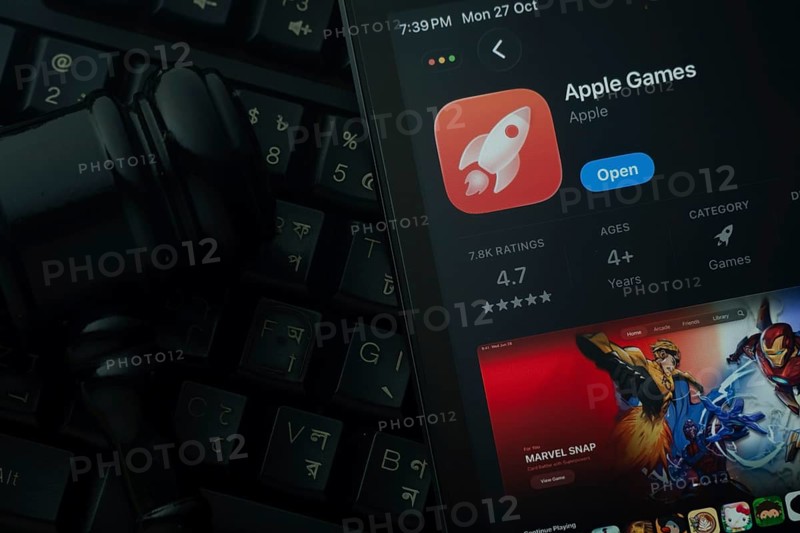 Dhaka, Bangladesh- 28 Oct 2025: An iPad displaying the Apple Games app against a judge's gavel and dark keyboard background