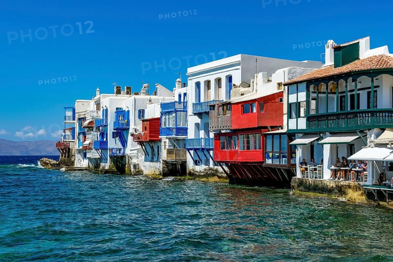 Mykonos, Cyclades, Greece - Little Venice is a picturesque neighborhood in Mykonos Town with colorful houses that stand right by the sea and are reminiscent of Venice. Little Venice is located on Alefkandra Bay next to the famous windmills of Mykonos. Mykonos is part of the Cyclades archipelago in the Aegean Sea