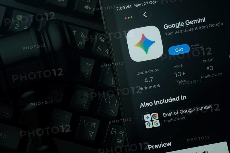 Dhaka, Bangladesh- 28 Oct 2025: An iPad displaying the Google Gemini app against a judge's gavel and dark keyboard background