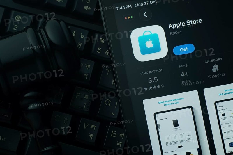 Dhaka, Bangladesh- 28 Oct 2025: An iPad displaying the Apple Store app against a judge's gavel and dark keyboard background